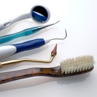 a toothbrush, dental picks, and a mouth mirror