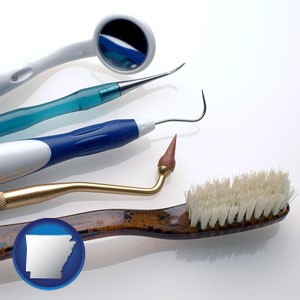 a toothbrush, dental picks, and a mouth mirror - with Arkansas icon