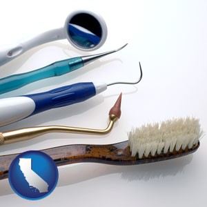 a toothbrush, dental picks, and a mouth mirror - with California icon