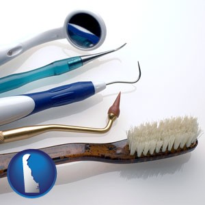 a toothbrush, dental picks, and a mouth mirror - with Delaware icon