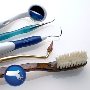 a toothbrush, dental picks, and a mouth mirror - with Massachusetts icon