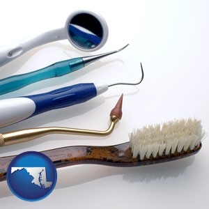 a toothbrush, dental picks, and a mouth mirror - with Maryland icon