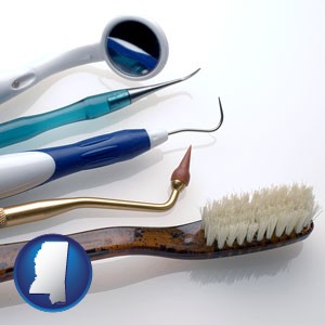 a toothbrush, dental picks, and a mouth mirror - with Mississippi icon