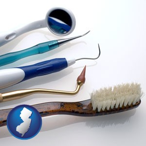 a toothbrush, dental picks, and a mouth mirror - with New Jersey icon