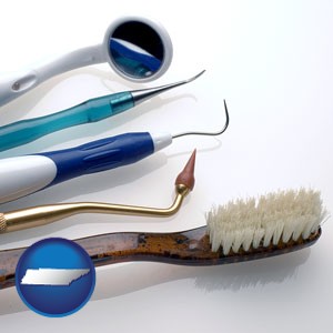 a toothbrush, dental picks, and a mouth mirror - with Tennessee icon