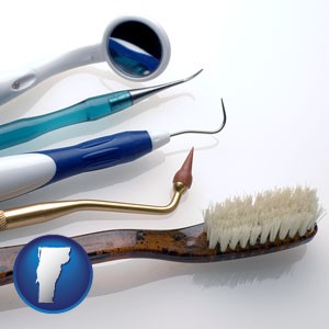 a toothbrush, dental picks, and a mouth mirror - with Vermont icon